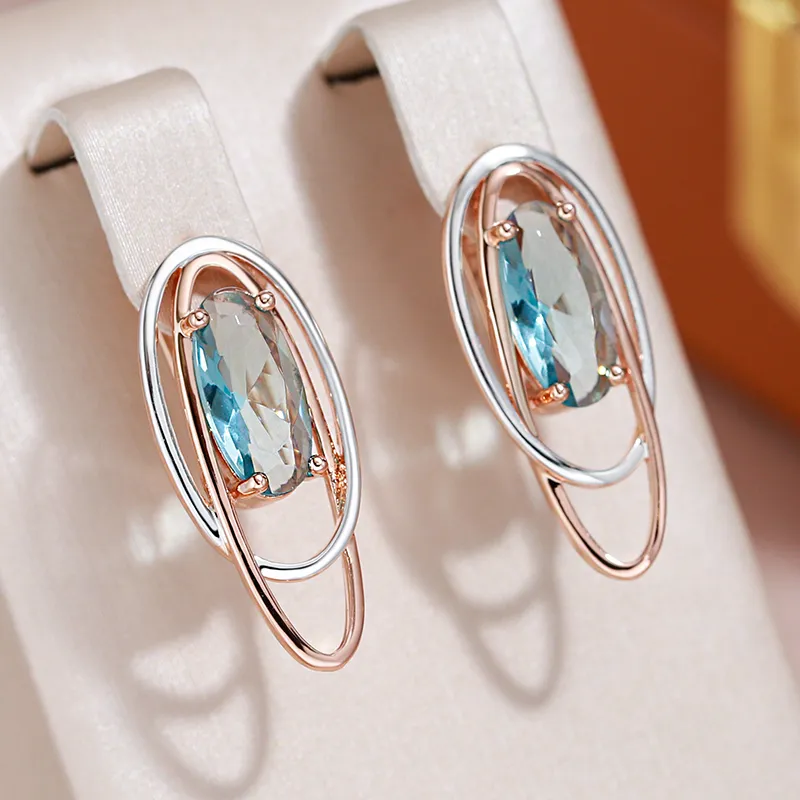 Elegante øreringe med blå zirkonia i guld og sølv
