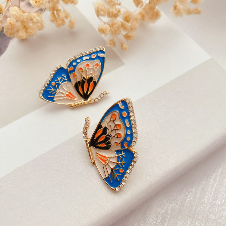 Vintage sommerfugleøreringe med blå emalje