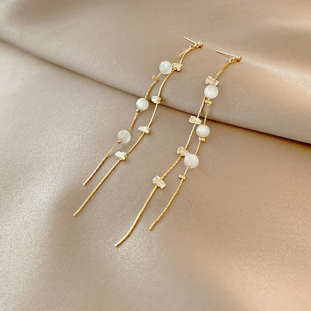 Øreringe i guld med zirkoner og perler